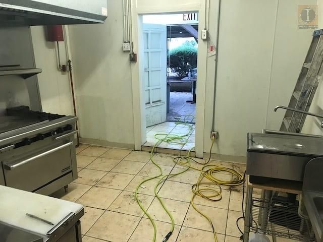 A kitchen with a door that says exit on it