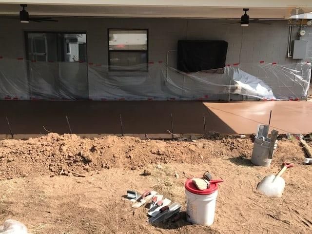 A large pile of dirt is sitting in front of a house.