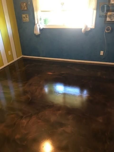A room with a shiny metallic floor and a window.