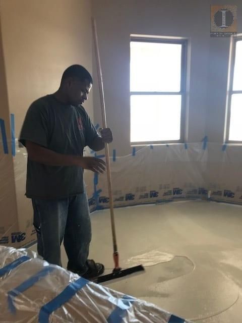 A man with a broom in a room with a sign that says 1