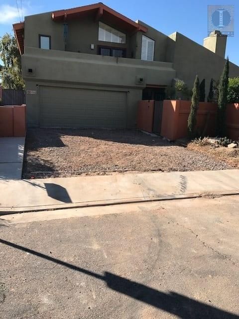 A large house with a shadow on the sidewalk