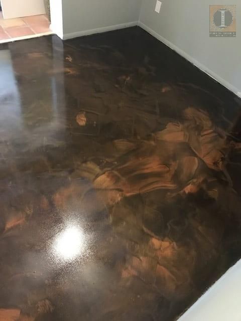 A dark colored concrete floor in a room