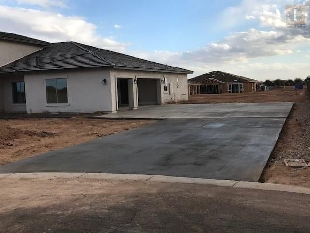 A concrete driveway is being built in front of a house.