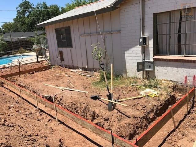 A house with a pool in the backyard is being remodeled.