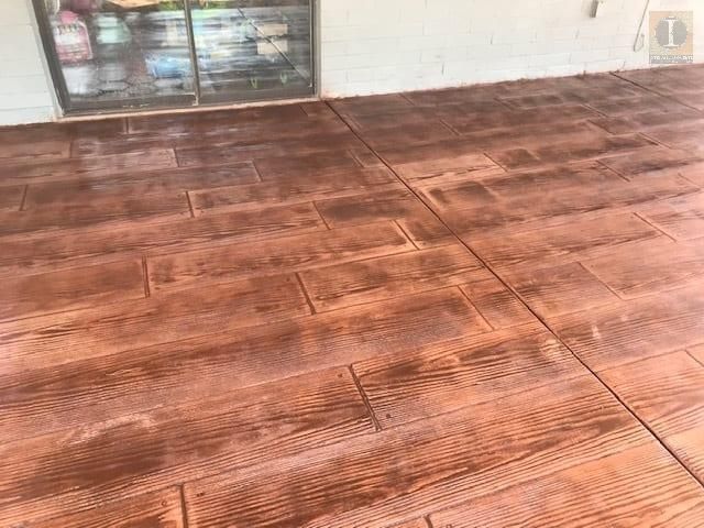 A patio with a concrete floor that looks like wood.