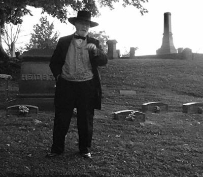 historical actor in woodland cemetery