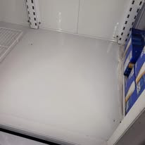 Inside of a mostly empty white refrigerator.