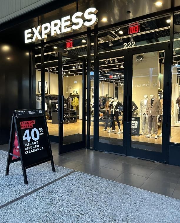 Express store exterior with black frame, glass doors, and 40% off sale sign.