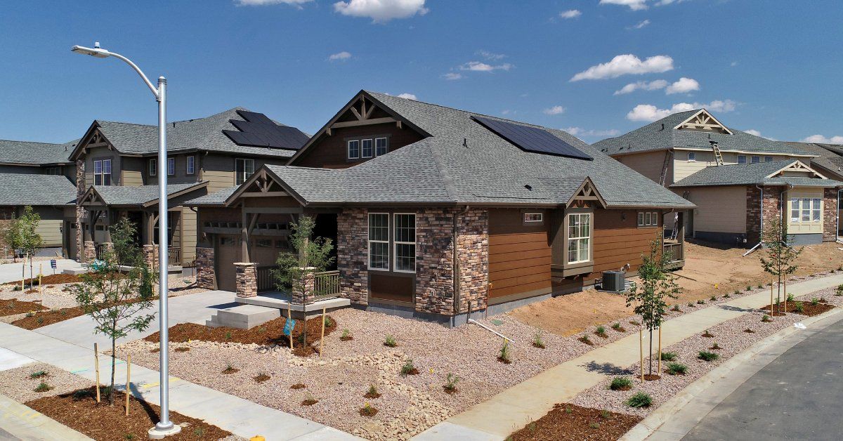 A corner property in California with river rock for landscaping and small, drought-resistant plants 