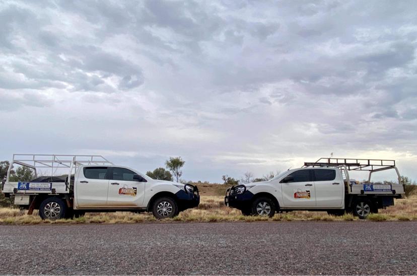 Two White Trucks Are Parked Next to Each Other on The Side of The Road — North West Queensland Painting in The Gap, QLD
