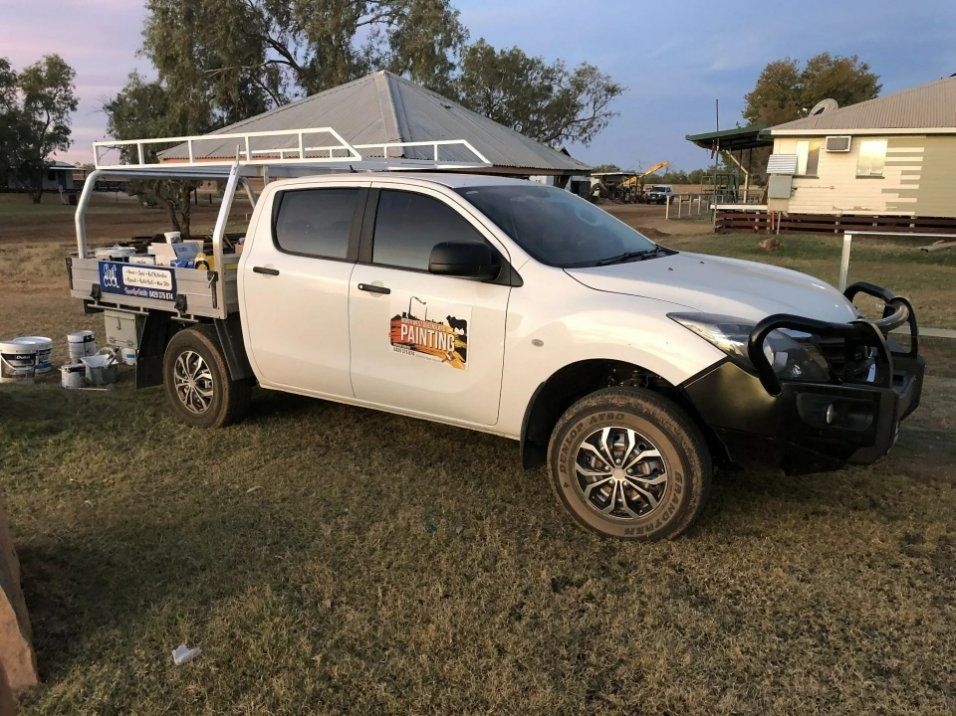 A White Truck Is Parked in The Grass in Front of A House — North West Queensland Painting in The Gap, QLD