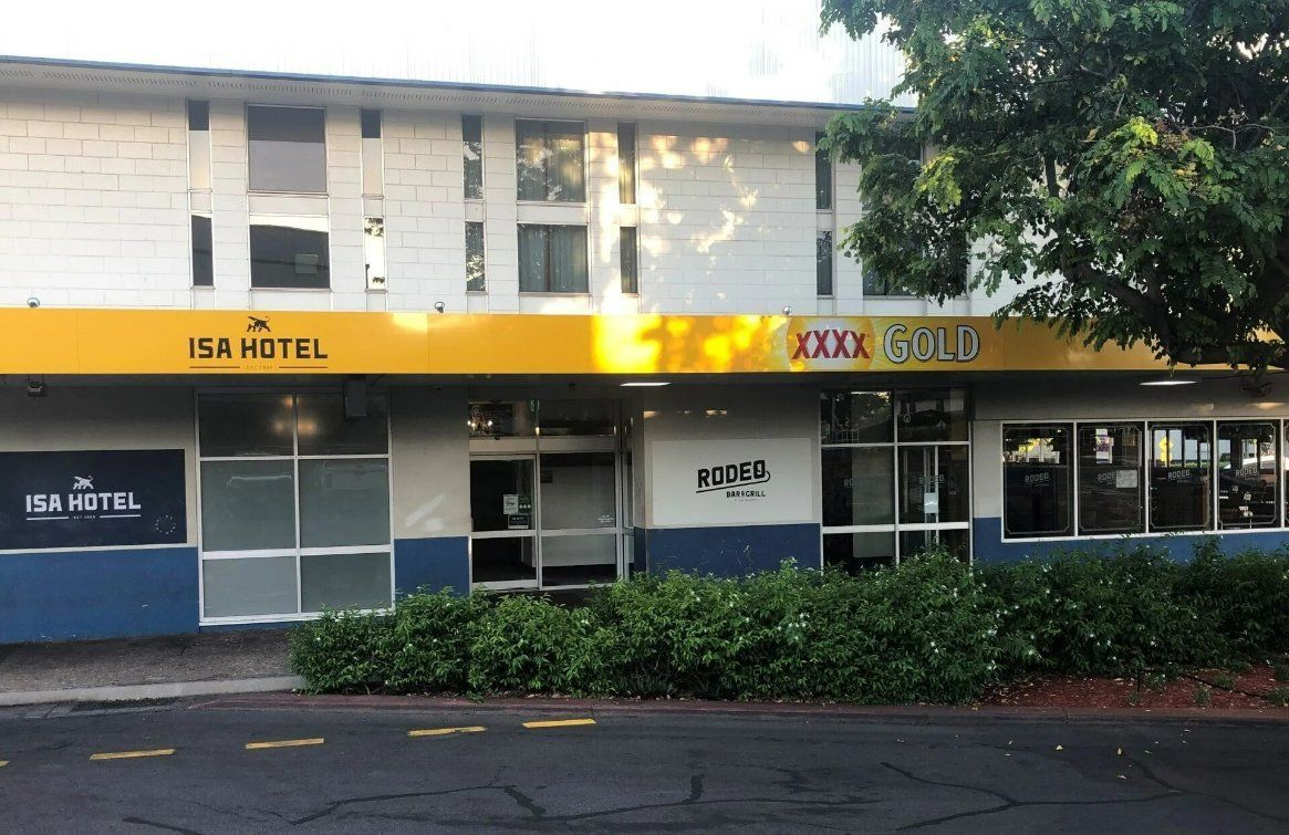 A White and Blue Building with A Yellow Awning that Says Isa Hotel — North West Queensland Painting in The Gap, QLD
