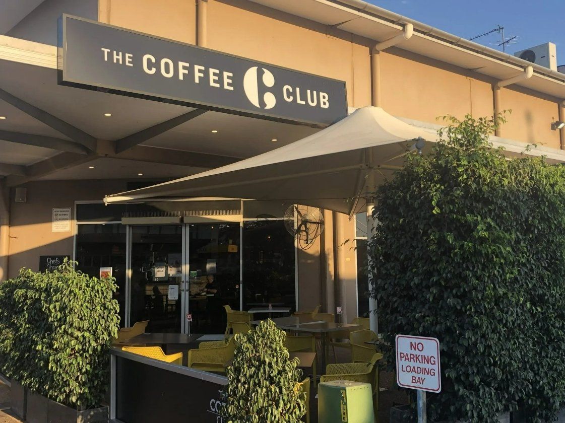 A Building with A Sign that Says the Coffee Club — North West Queensland Painting in Mornington Island, QLD