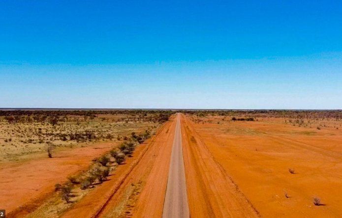 An Aerial View of A Dirt Road in The Middle of A Desert — North West Queensland Painting in The Gap, QLD