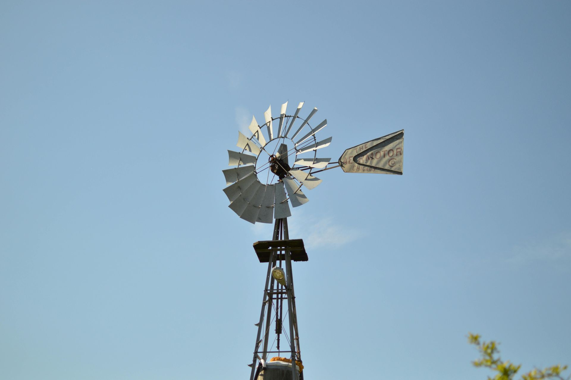 A windmill with a blue sky in the background