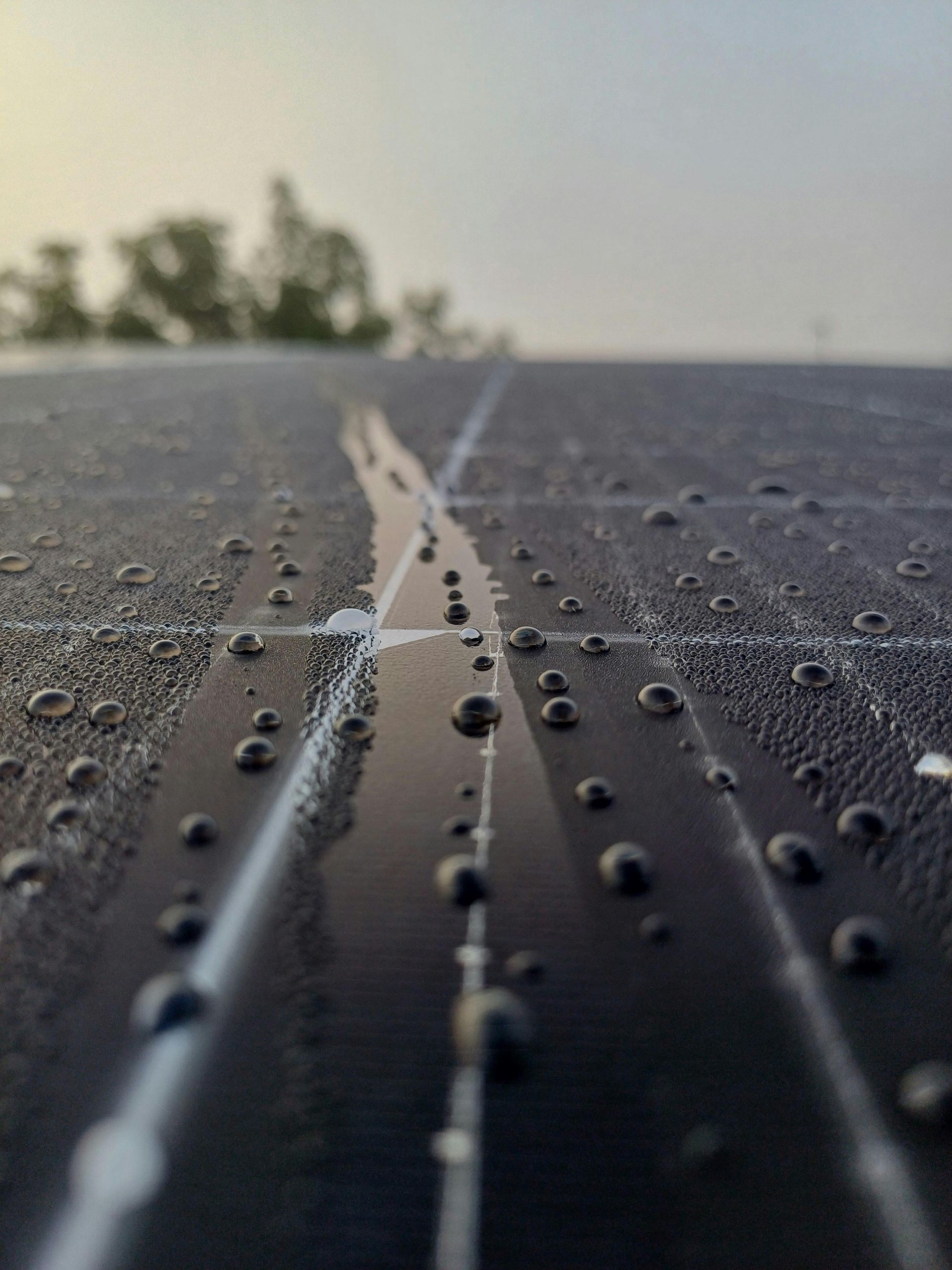 A close up of a solar panel with water drops on it.
