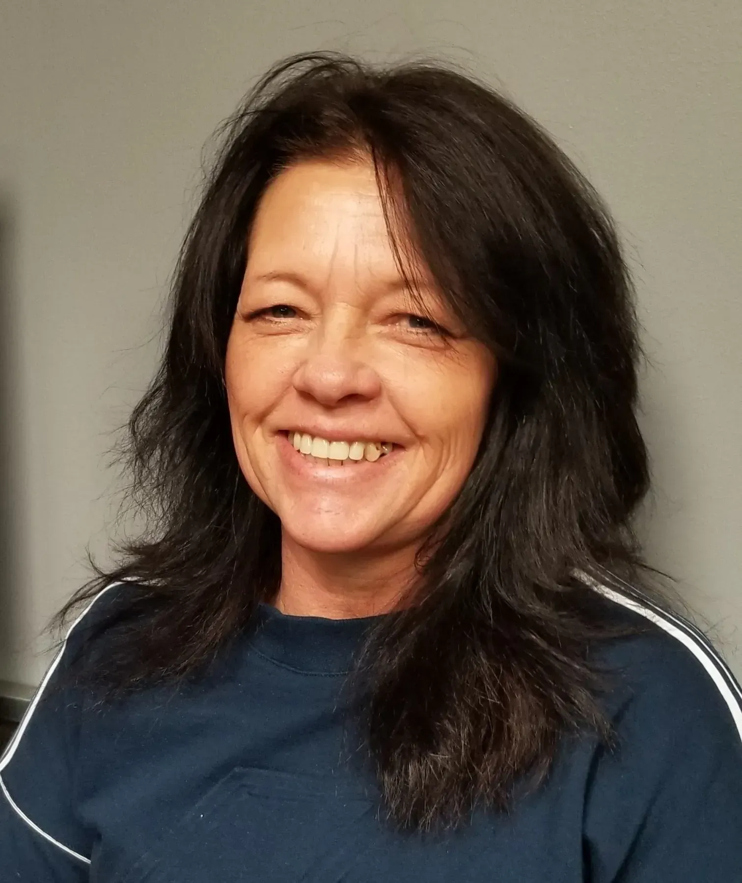 A man with a beard is standing in front of a sign that says 66.