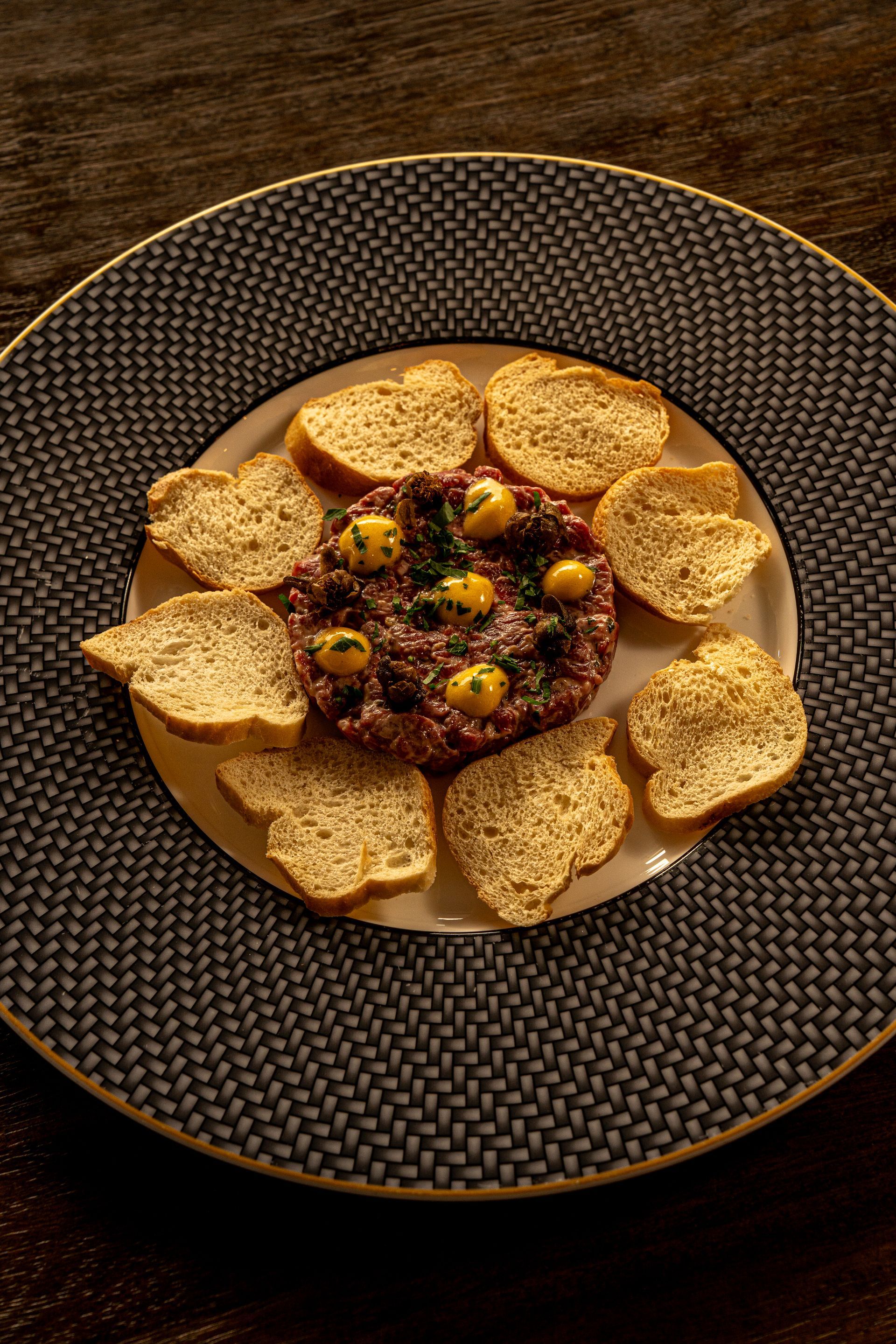 Wagyu tartare with anchovy cream, egg yolk and crispy baguette. 