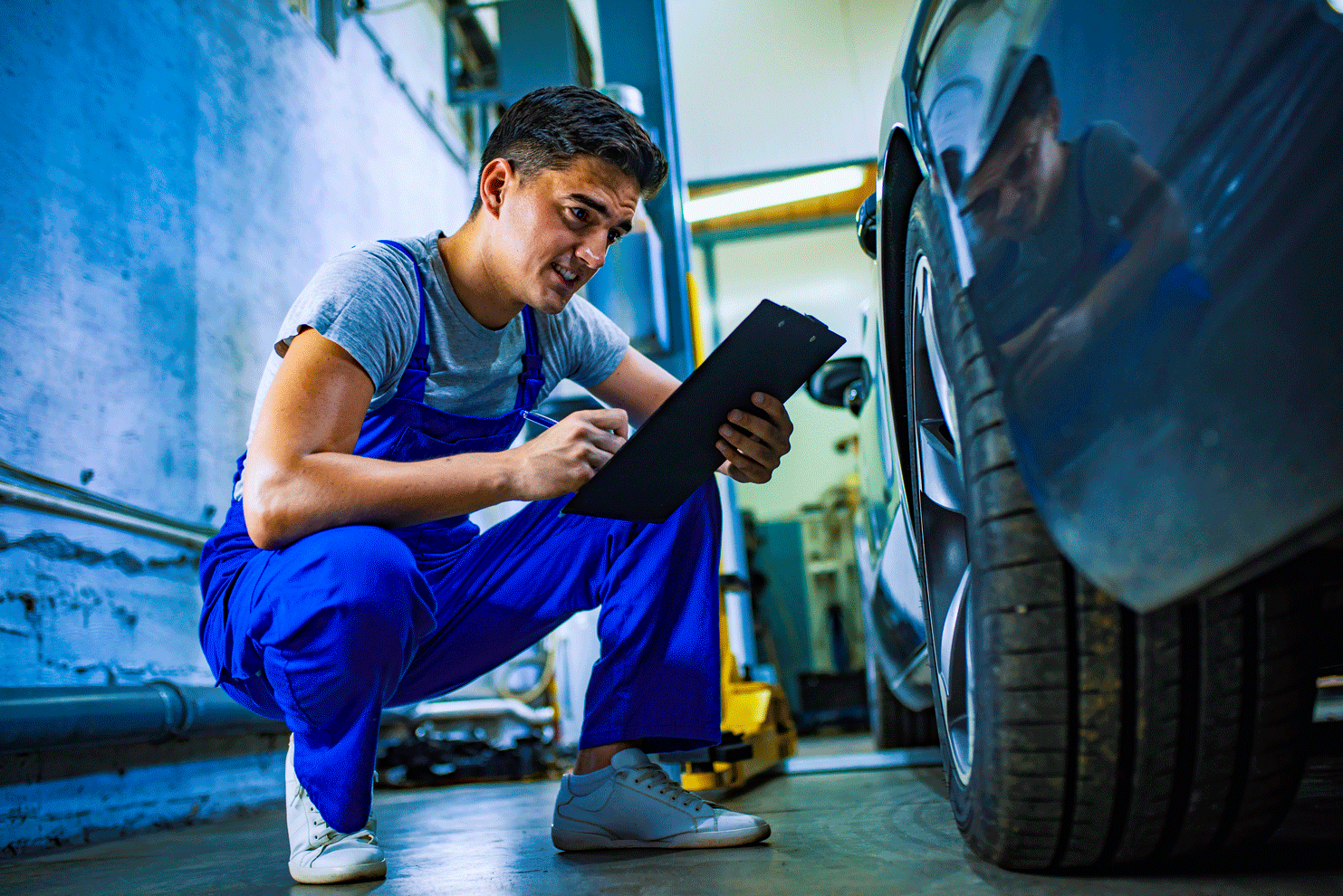 Man Reading Notes Besides The Car | Memphis, TN | Airways Tire And Alignment Co Inc