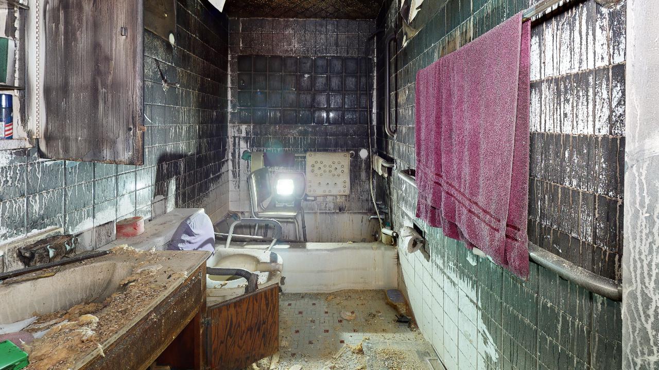 A bathroom with a bathtub , sink , and mirrors.