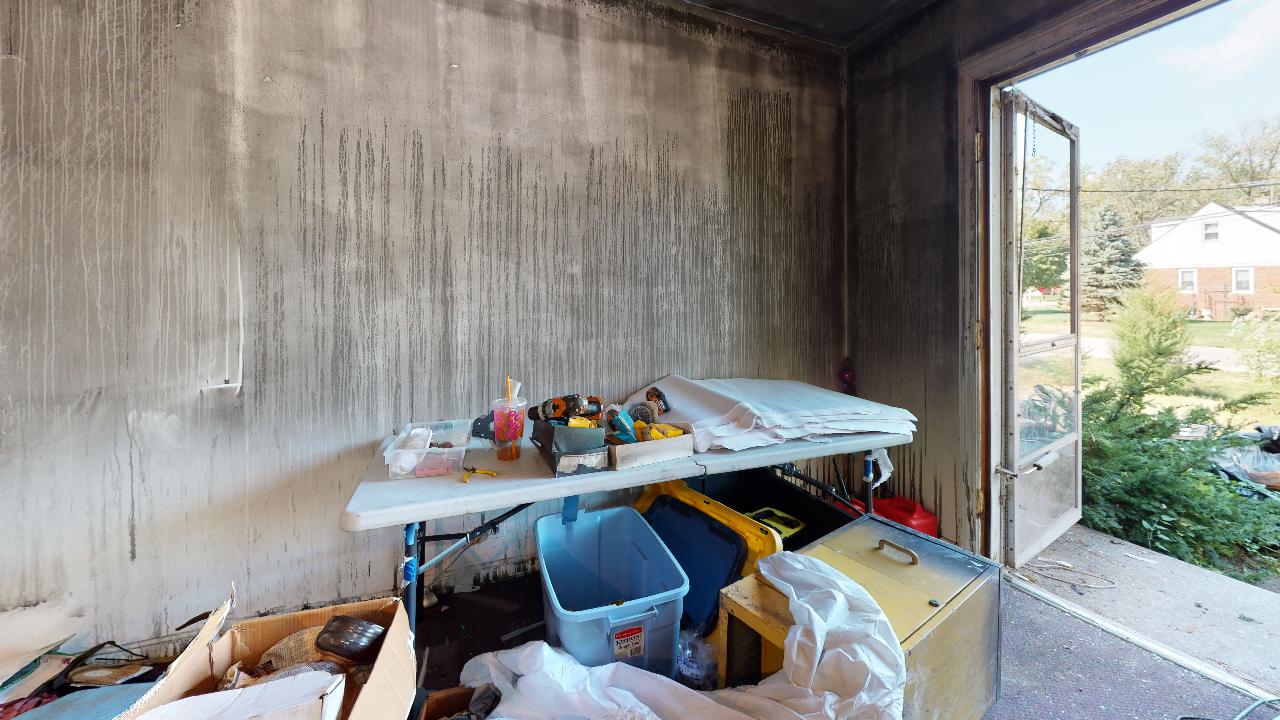 A messy room with a table and boxes in it.