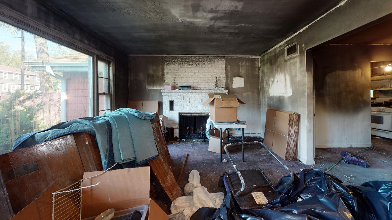 A living room filled with boxes and a fireplace.