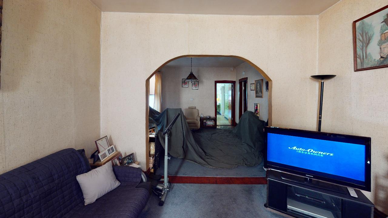 A living room with a couch and a flat screen tv