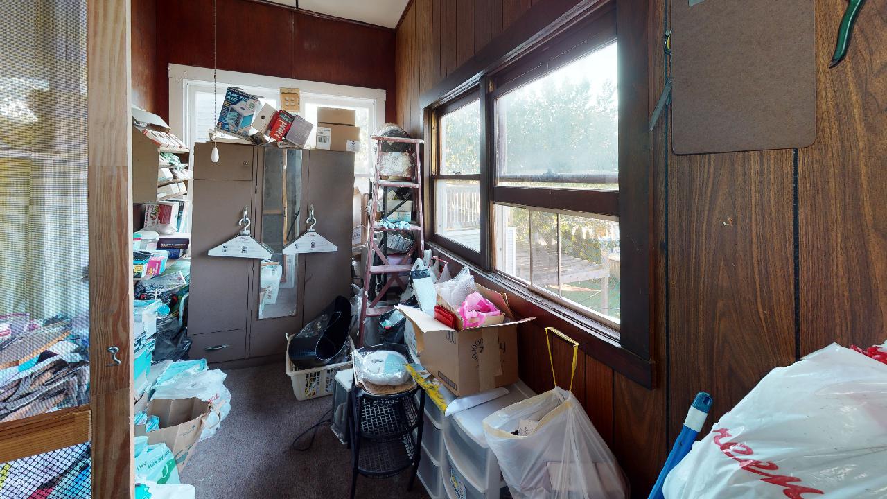 A room with a lot of stuff in it and a window.