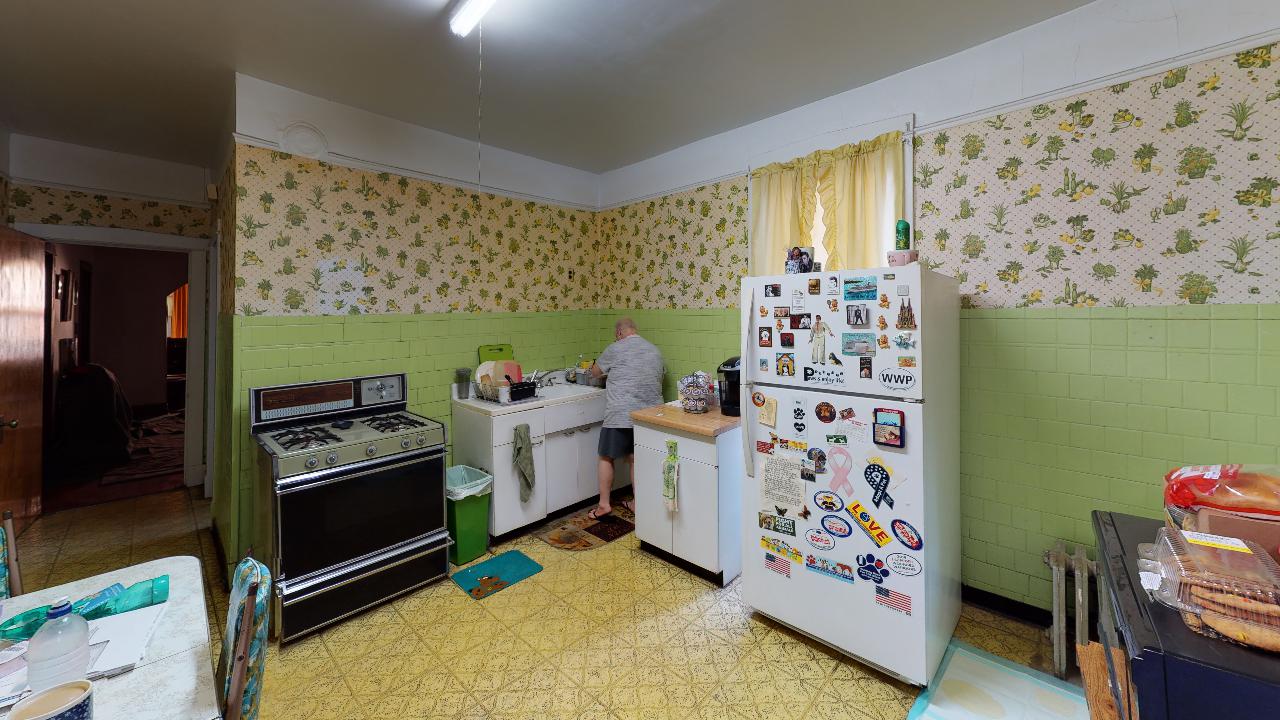 A kitchen with a refrigerator , stove , and sink.