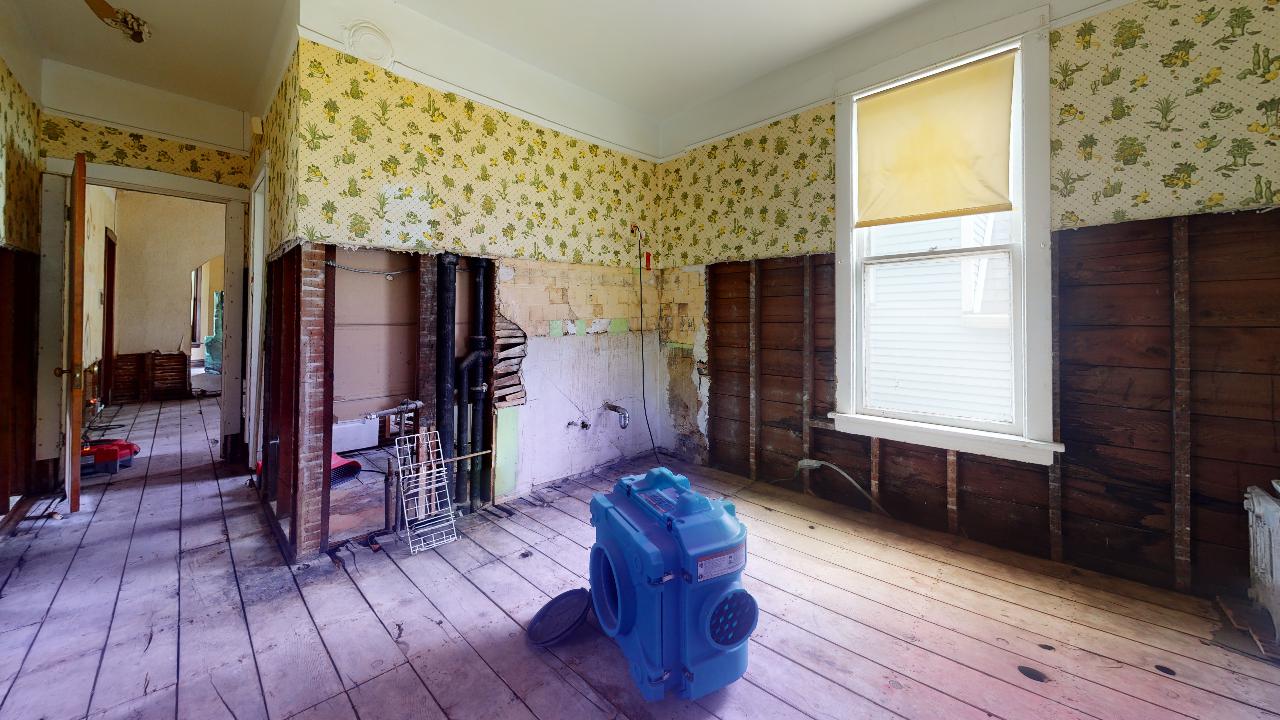 There is a vacuum cleaner in the middle of the room.