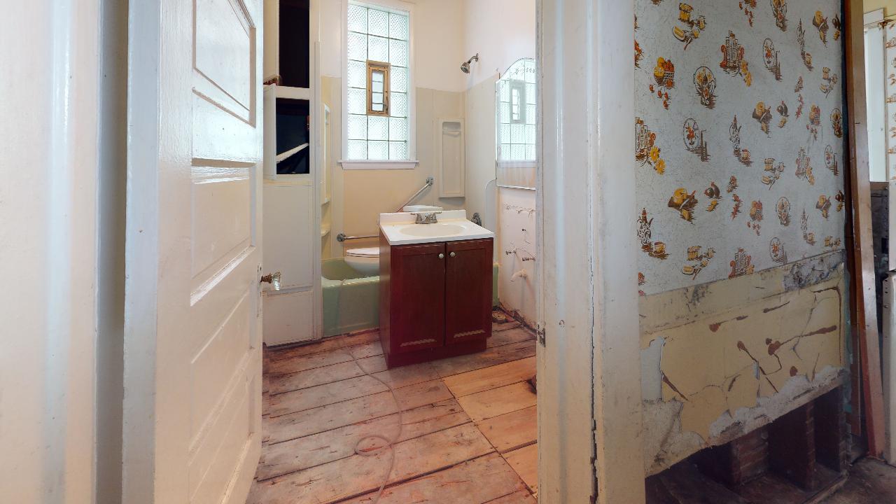 A bathroom with a sink , toilet , and shower.