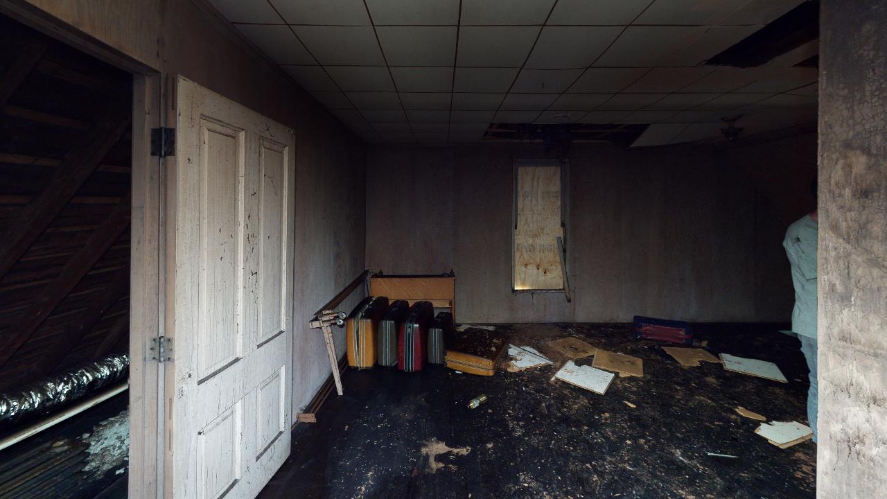 An empty room with a lot of papers on the floor