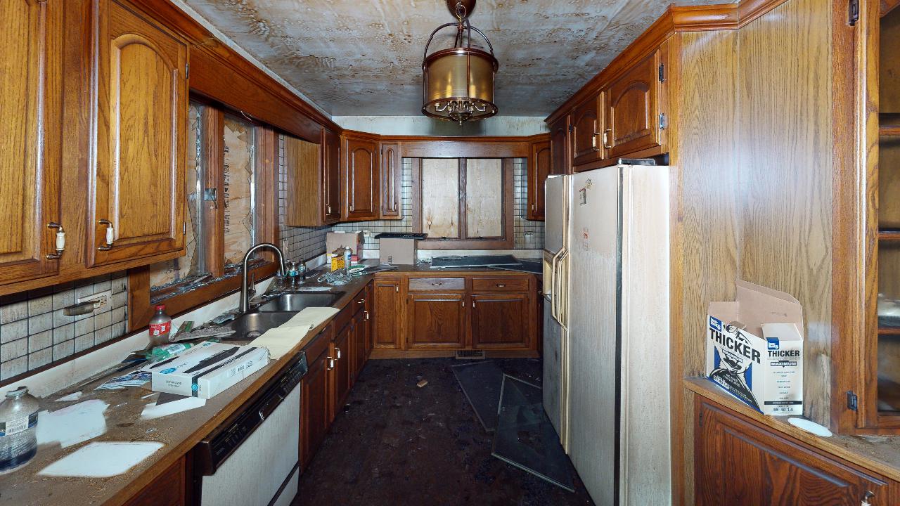 A kitchen with wooden cabinets and a white refrigerator