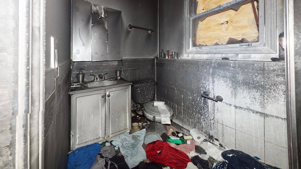 A kitchen with a sink , cabinets , and a window.