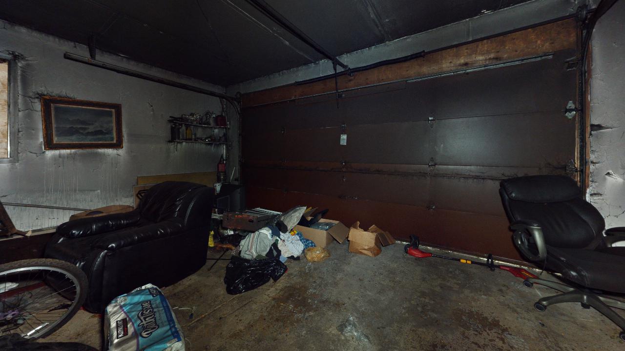 A garage filled with lots of furniture and boxes.