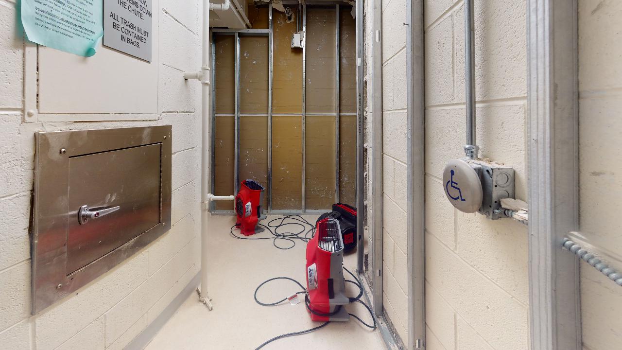 A hallway with a vacuum cleaner in the middle of it.