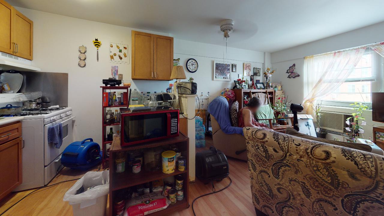 A living room with a couch and a microwave in it