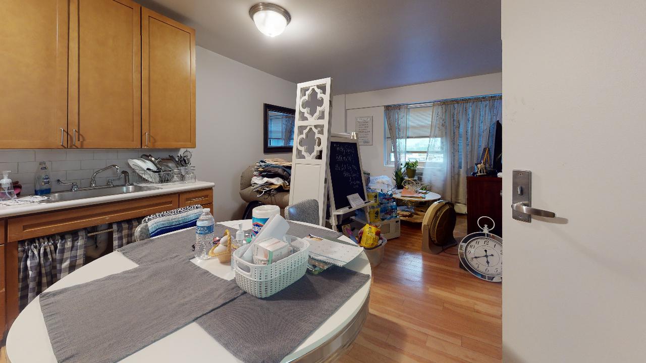 A kitchen with a table and a sink in it.