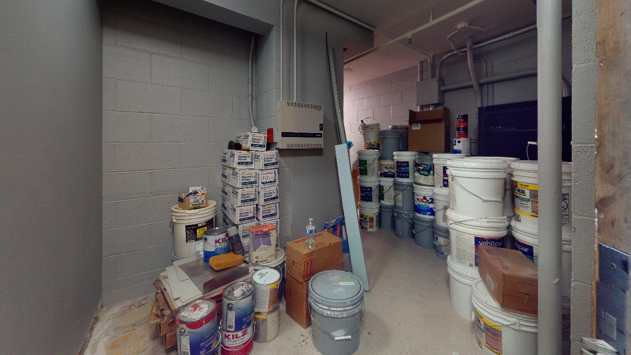 A room filled with buckets of paint and other items.