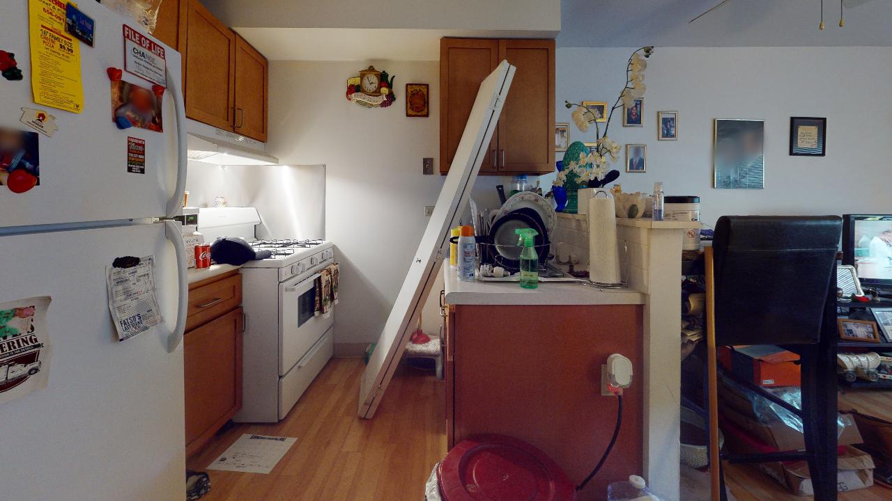 A kitchen with a refrigerator that says ' coca cola ' on it