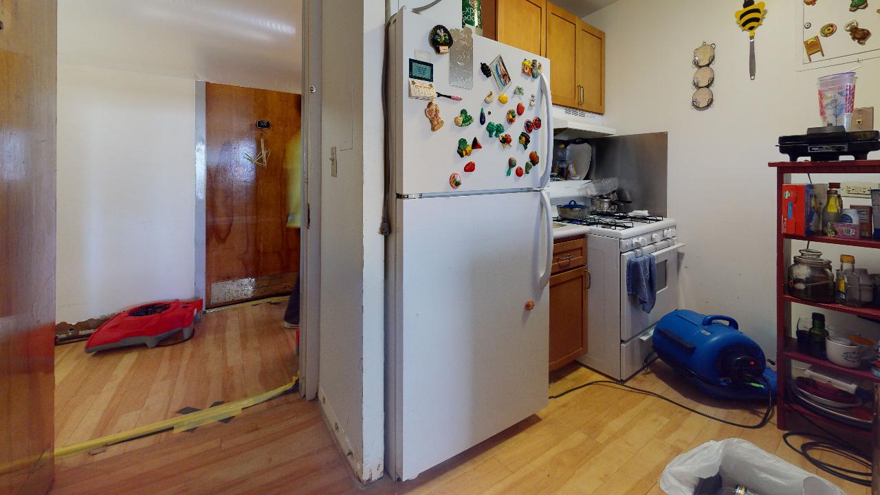 A kitchen with a refrigerator and stove in it