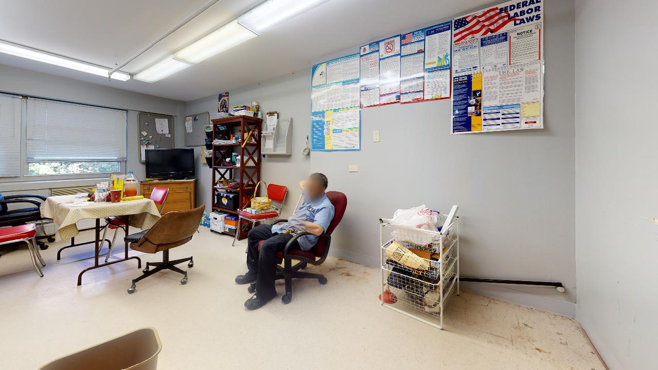 A man is sitting in a chair in a living room.
