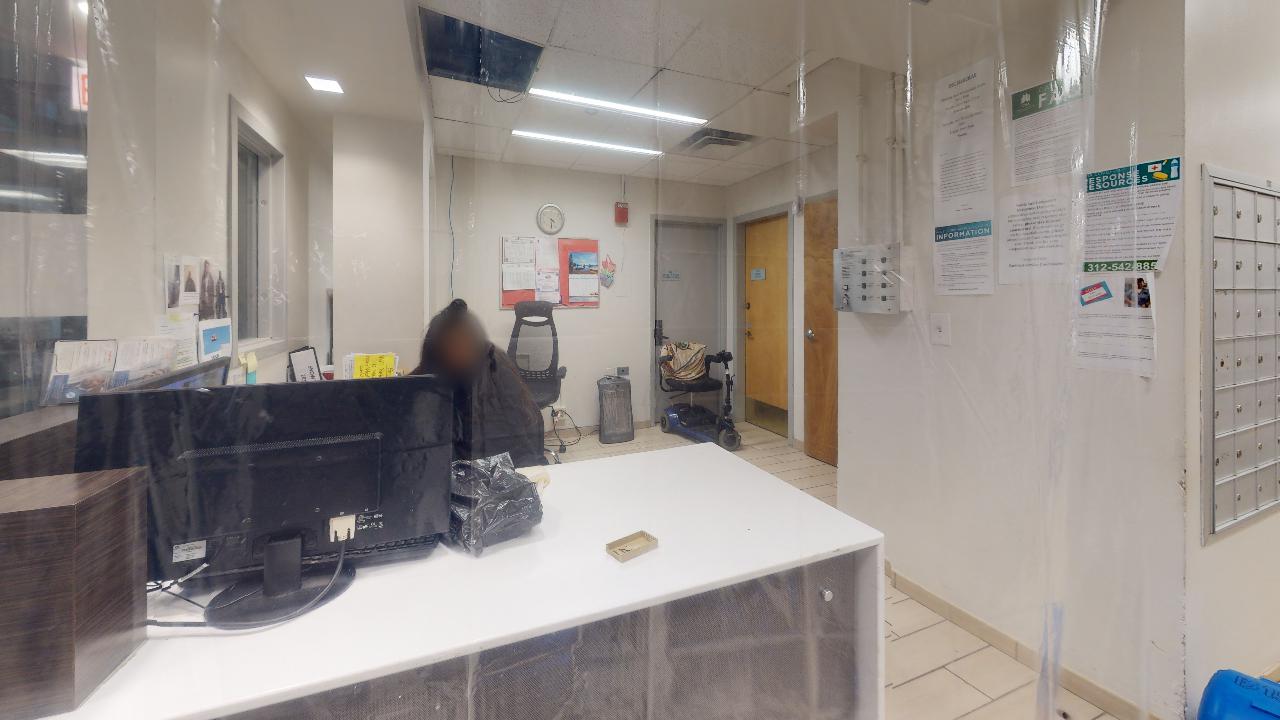 A reception area in a hospital with a desk and a computer.