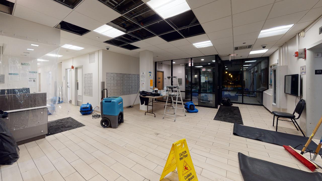 A large room with a yellow caution sign on the floor.