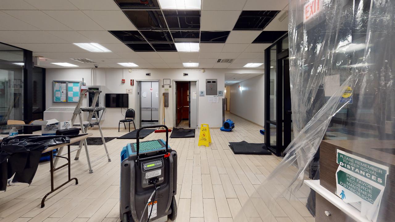 There is a yellow wet floor sign in the middle of the room.