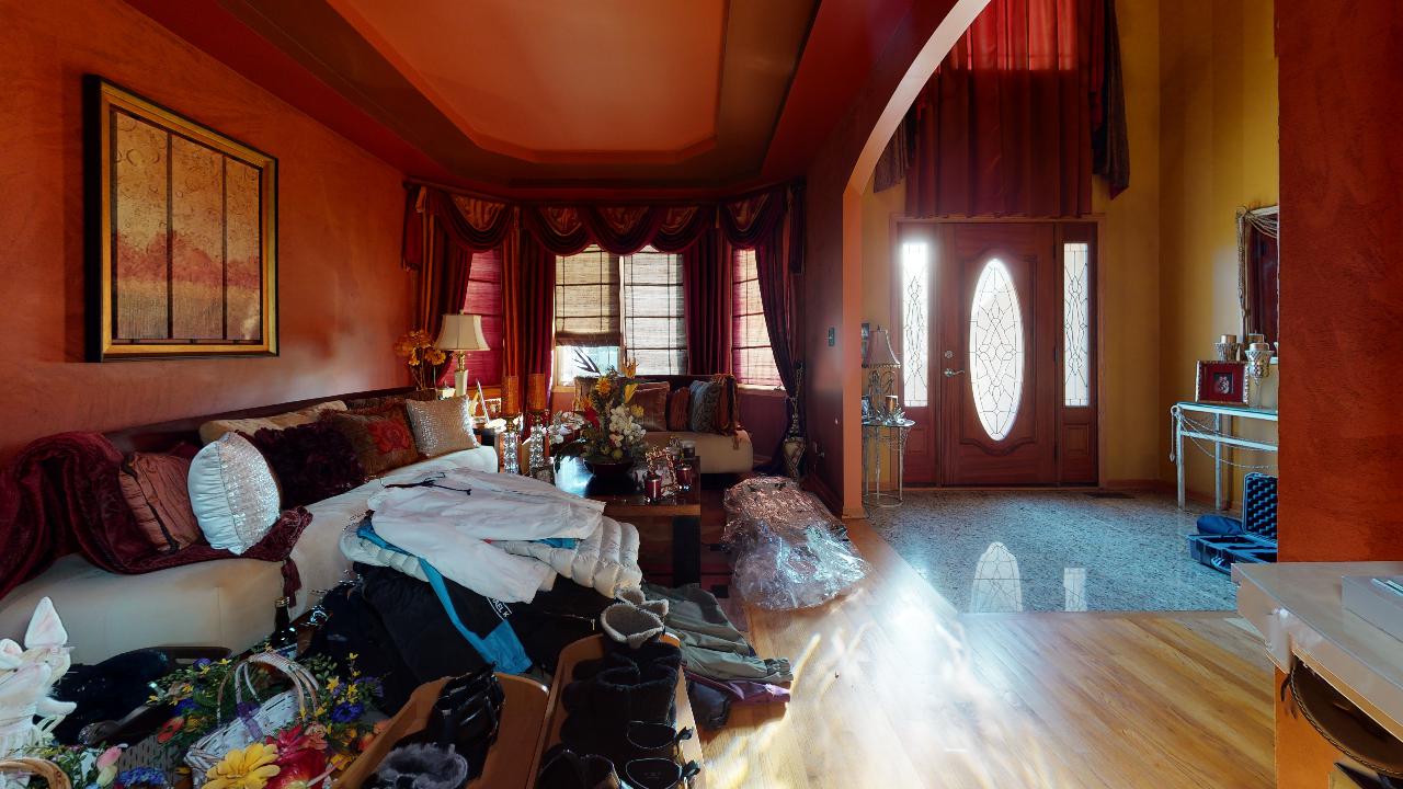 A living room with a lot of furniture and a door.