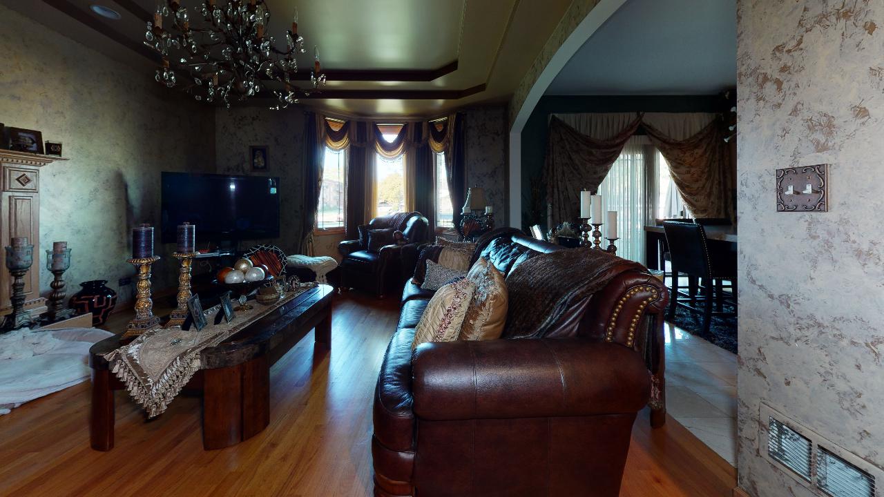 A living room with a couch , table , and television.