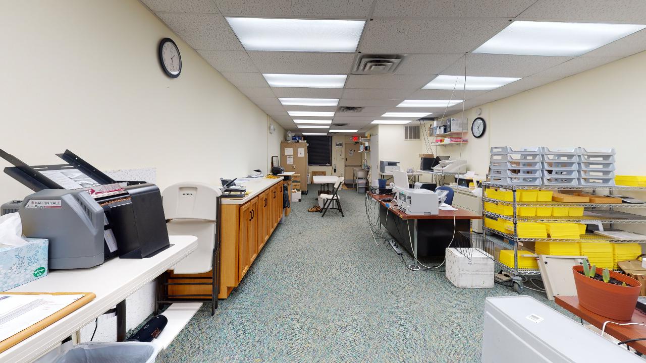 An empty office with a clock on the wall