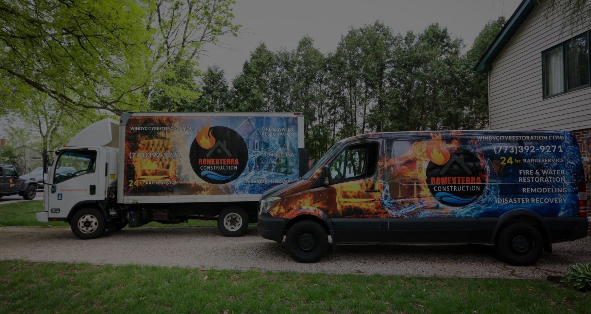 Two trucks are parked next to each other in front of a house.