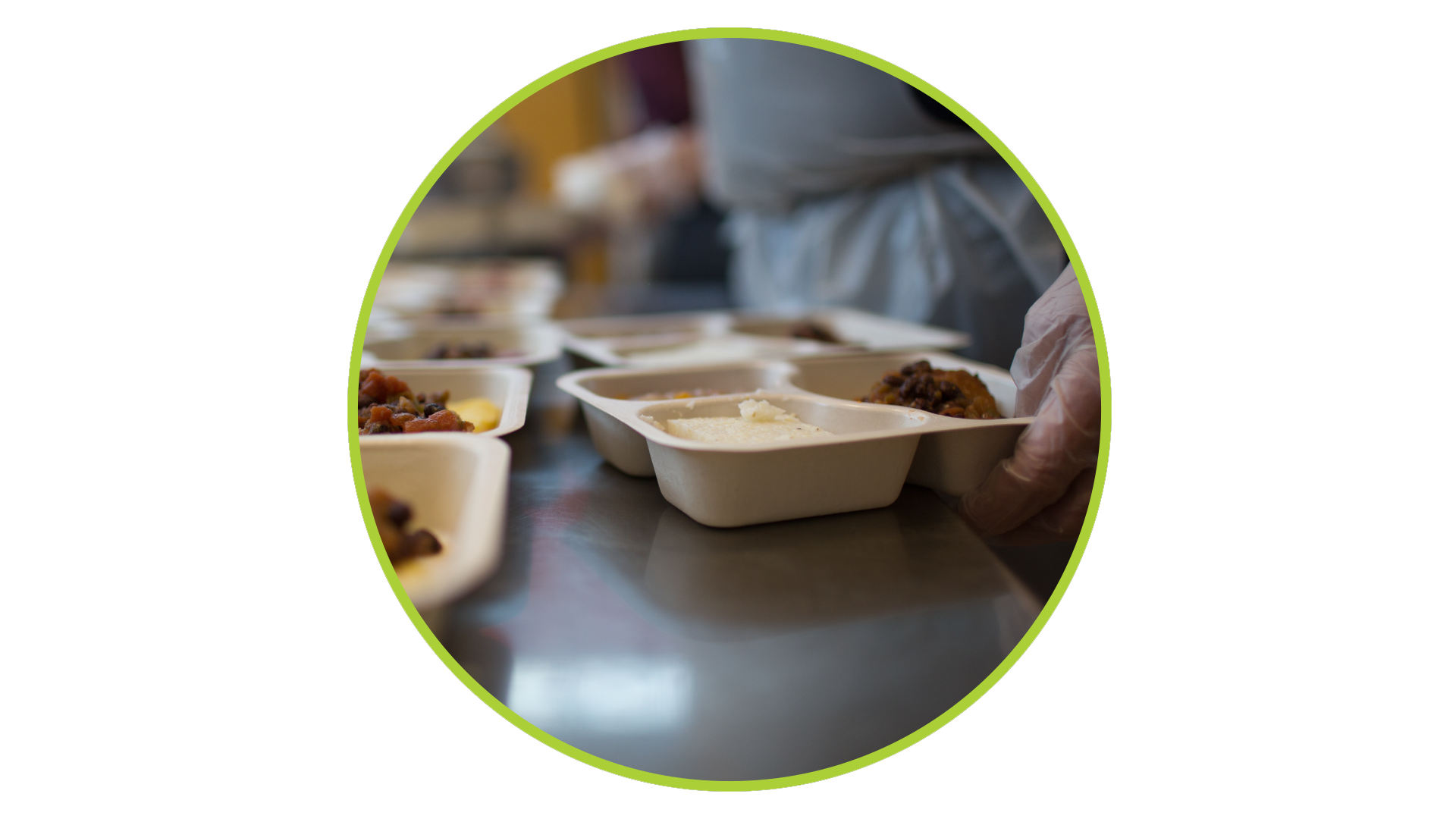 Person preparing meals in divided serving trays.